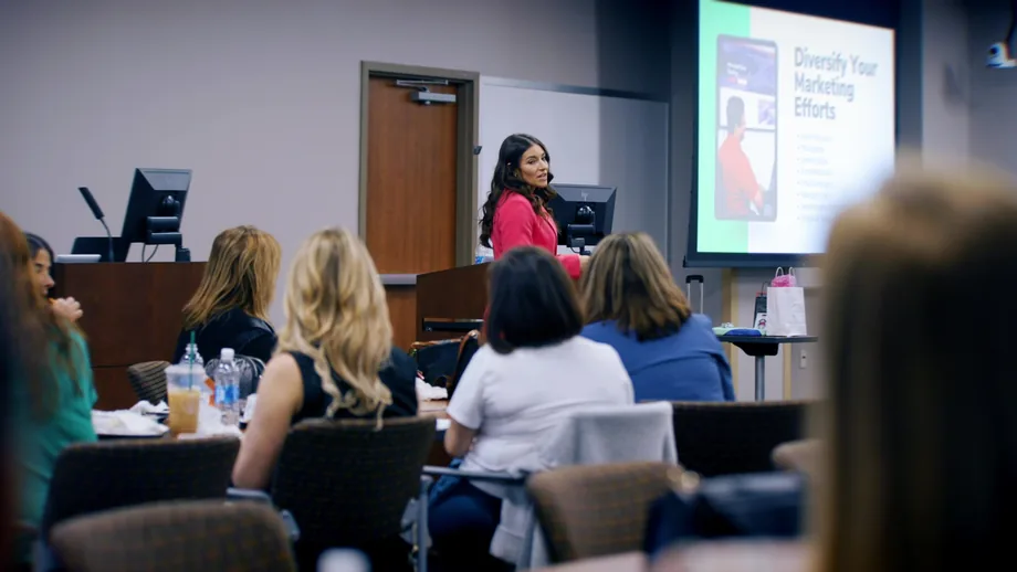 Presenter delivering a Diversify Your Marketing Efforts workshop to a seated audience