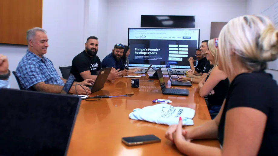 TradeUp Marketing presenting a new roofing website to a client team around a boardroom table