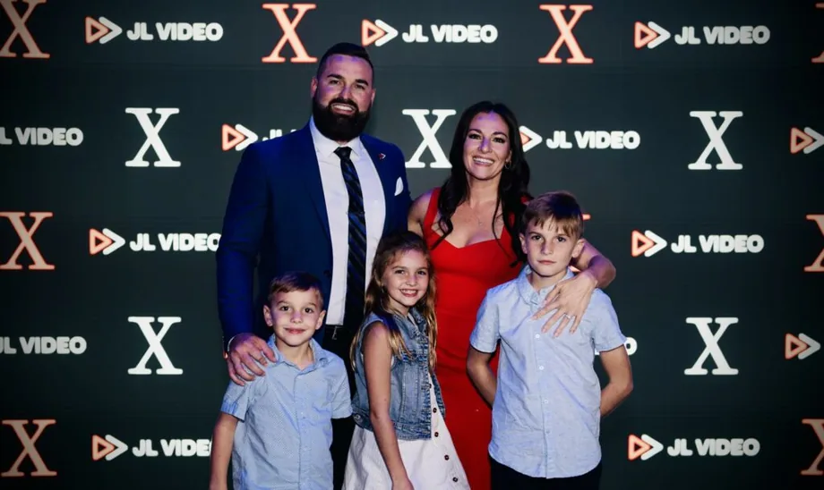 Jordan Lung with his family on a JL Video step-and-repeat backdrop