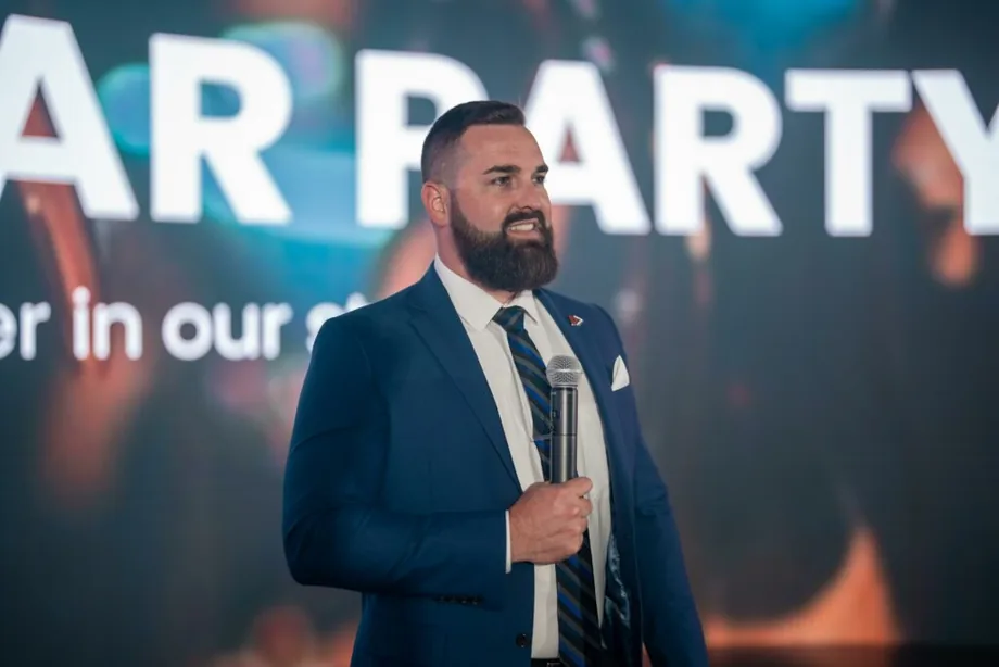 Jordan Lung speaking on stage with a microphone