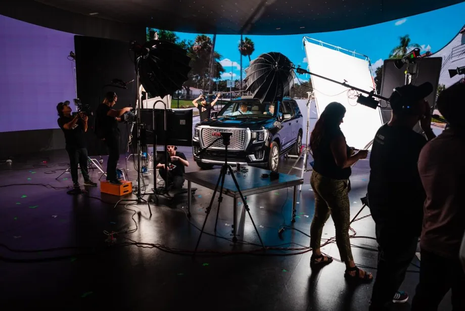 Cinema cameras and lighting rigs shooting a vehicle on an LED stage