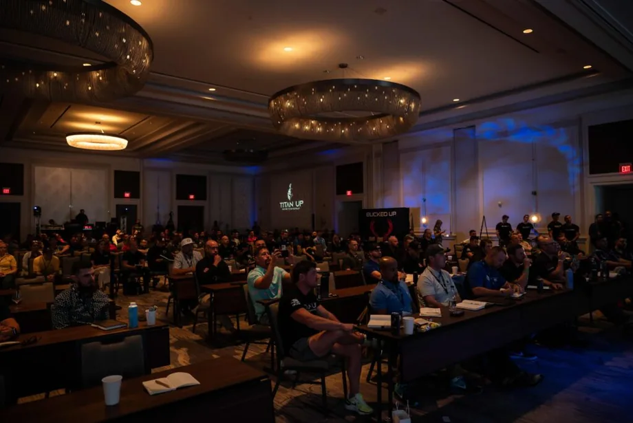 Audience seated at tables in a hotel ballroom during a marketing conference