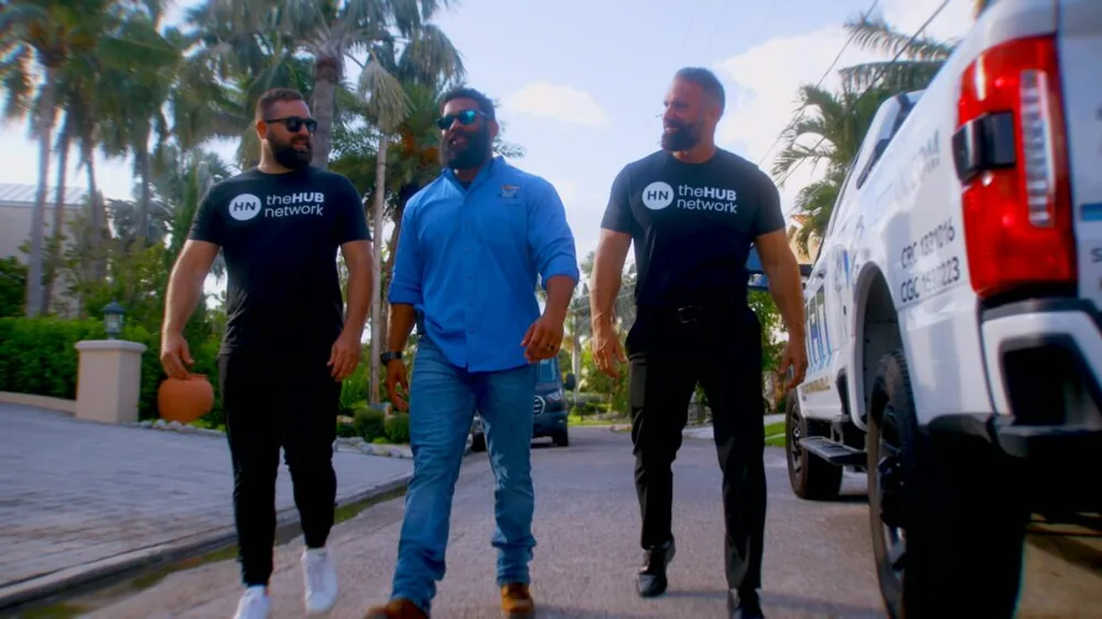 theHUB network team walking with a client beside a service truck