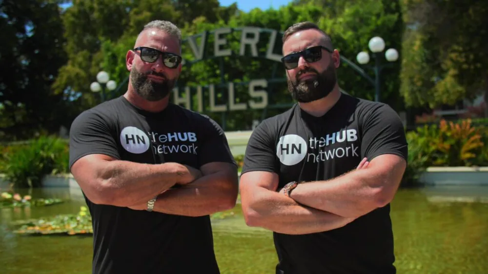 Regan Weiss and Jordan Lung in theHUB network shirts at the Beverly Hills sign
